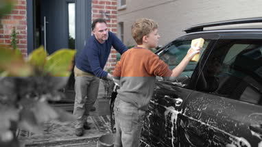 Son helping Father wash car