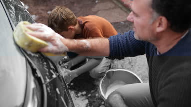 Father and Son washing a car together