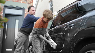 Father and Son washing the family car together