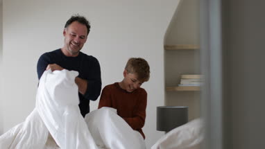 Father and Son making a bed