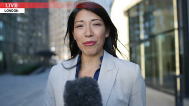 Female news presenter talking to camera