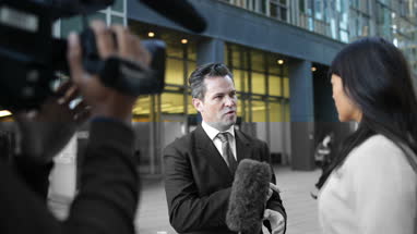 Businessman being interviewed on the street