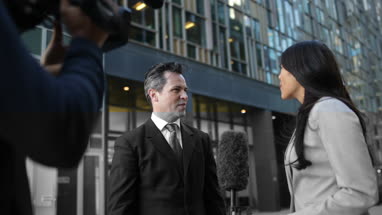 Businessman being interviewed on the street