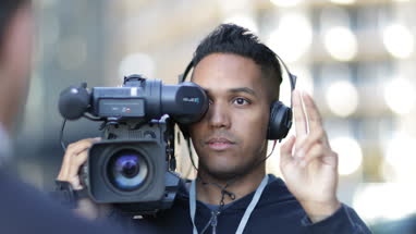 TV presenter being counted in by cameraman