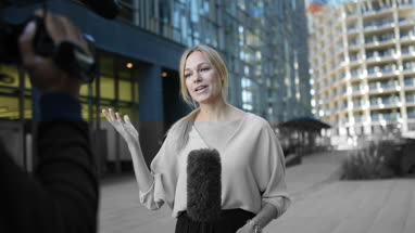 News presenter reporting to camera