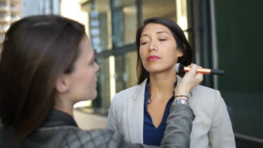 TV presenter having make-up applied on location