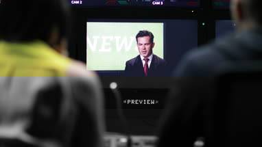 Control room speaking to presenter in TV studio