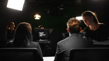 TV presenter having make-up applied on set