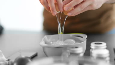 Close-up of man cracking an egg