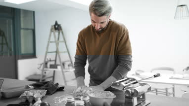 Adult male making pasta dough