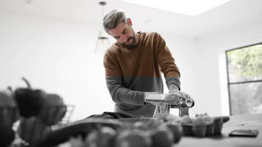 Adult male using a pasta machine