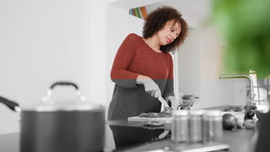 African American female chopping tomatoes