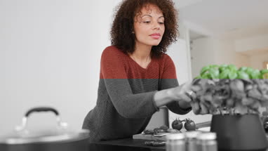 Adult female picking fresh basil
