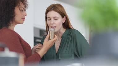 Close-up adult female smelling a spice