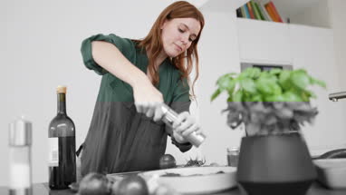 Adult female seasoning a dish