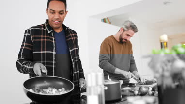 Adult male friends preparing a meal together