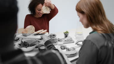 Male passing bread at a meal