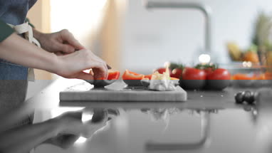Close-up of female cutting red bell pepper