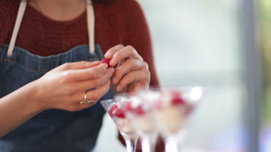 Female cook putting final touches to desert