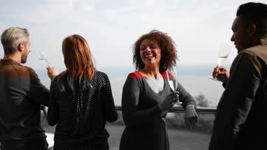 Friends enjoying view from balcony of sea