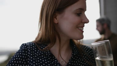 Friends enjoying view from balcony of sea