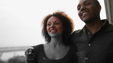 Couple enjoying view from balcony of sea