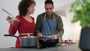 Adult male preparing dinner for girlfriend