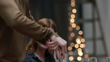 Close-up adult male serving Christmas meal to friends