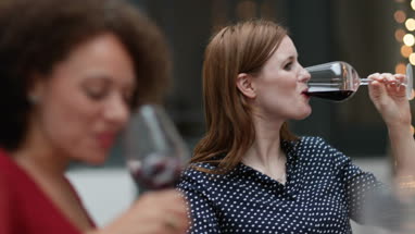 Female friends drinking red wine 