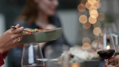 Friends passing food at a meal