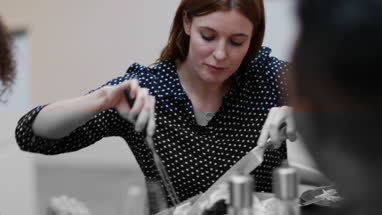 Close-up adult female serving Christmas meal to friends