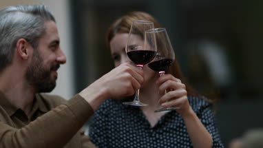 Male pouring friends wine at a meal
