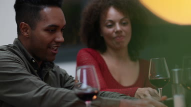 Couple looking at smartphone together at a meal