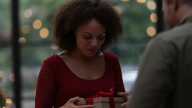 Woman being given Christmas gift