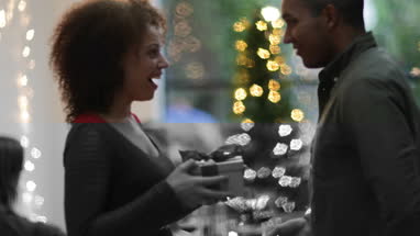 Woman being given Christmas gift