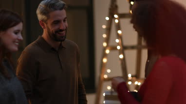 Friends bringing bottle of wine to a party