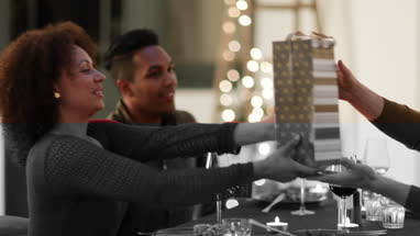 Friends giving a gift of wine at a dinner party