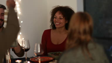 Friends giving a gift of wine at a dinner party