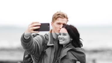 Young couple taking a selfie on a camping trip