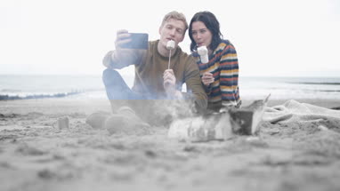 Young couple taking a selfie of their winter break