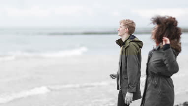 Group of friends skimming stones together