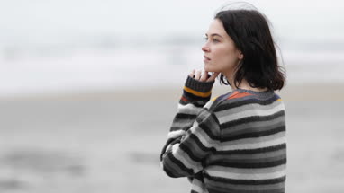Young female looking at sea thoughtfully