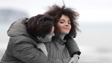 Couple hugging on a beach in winter
