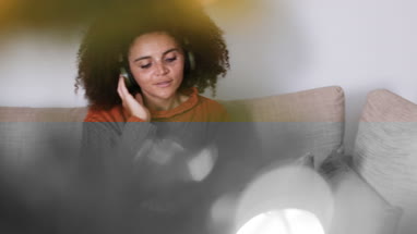 Young adult female listening to Christmas songs