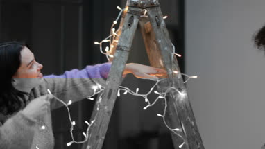 Friends decorating an alternative christmas tree