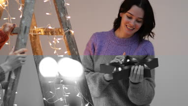 Friends decorating an alternative christmas tree