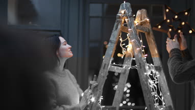 Couple decorating an alternative christmas tree