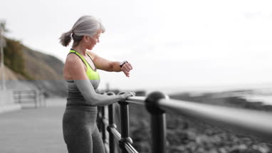 Active senior woman running with younger woman