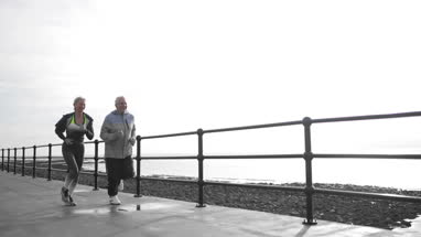 Senior woman checking activity tracker on a run