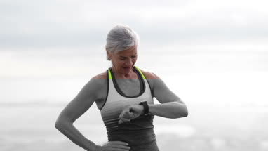 Senior woman showing daughter photos on a smartphone